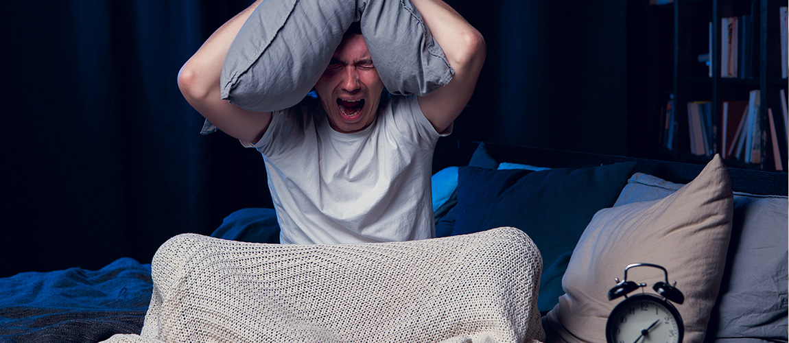 a person sitting in bed unable to sleep